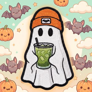 May include: An embroidered patch featuring a white ghost wearing an orange beanie with a small black bat logo. The ghost holds a clear plastic cup filled with a green iced beverage and a black straw, outlined in thick black thread against a background.