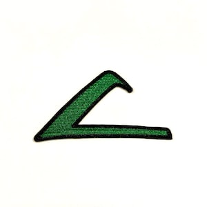 May include: A green embroidered patch in the shape of a stylized letter "L" with a black border. The patch is on a white background. The patch is likely for clothing or accessories.
