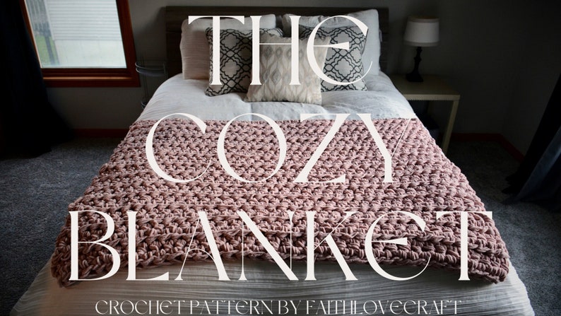 May include: A pink crocheted blanket on a bed with white bedding and pillows. The blanket is textured and has a "The Cozy Blanket" title with the text "Crochet Pattern by FaithLoveCraft" at the bottom.
