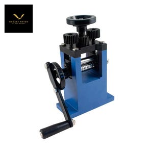 May include: A blue metal rolling mill with black gears and a hand crank. The machine has a rectangular base and a series of rollers. The brand logo "SNEAKY RAVEN" is in the upper left corner. This tool is used for jewelry making and metalworking.