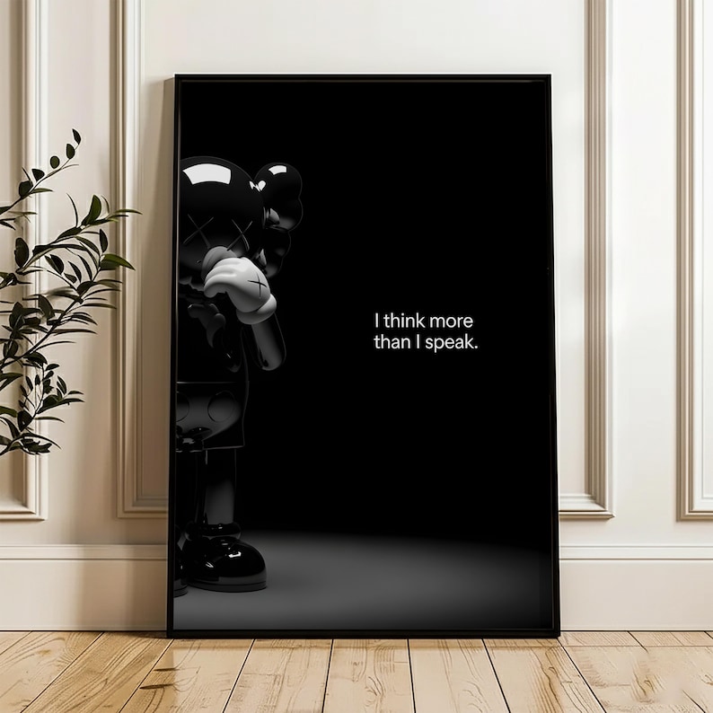 Puede incluir: Impresi&oacute;n art&iacute;stica enmarcada en negro con una figura negra brillante con guantes blancos y una cruz blanca en cada mano. El texto "I think more than I speak" se muestra en blanco sobre un fondo negro.