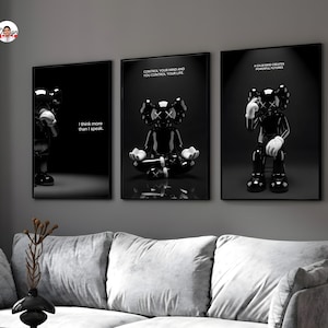 Puede incluir: Conjunto de tres impresiones art&iacute;sticas enmarcadas en negro con una figura de dibujos animados en blanco y negro en varias poses. Cada impresi&oacute;n tiene una cita diferente: "Pienso m&aacute;s de lo que hablo", "Controla tu mente y controlas tu vida" y "Una mente tranquila crea futuros poderosos."