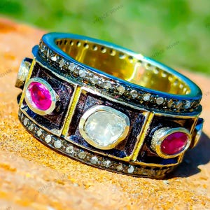 May include: A white ceramic mug with a black handle and the text "But First, Coffee" in a black, bold font. The mug is on a white surface.