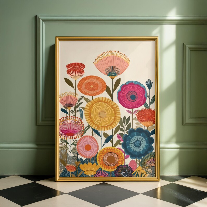 May include: A framed floral art print featuring colorful stylized flowers in shades of pink, orange, yellow, and blue. The artwork is set against a cream background and framed in gold. The print is displayed against a green wall.