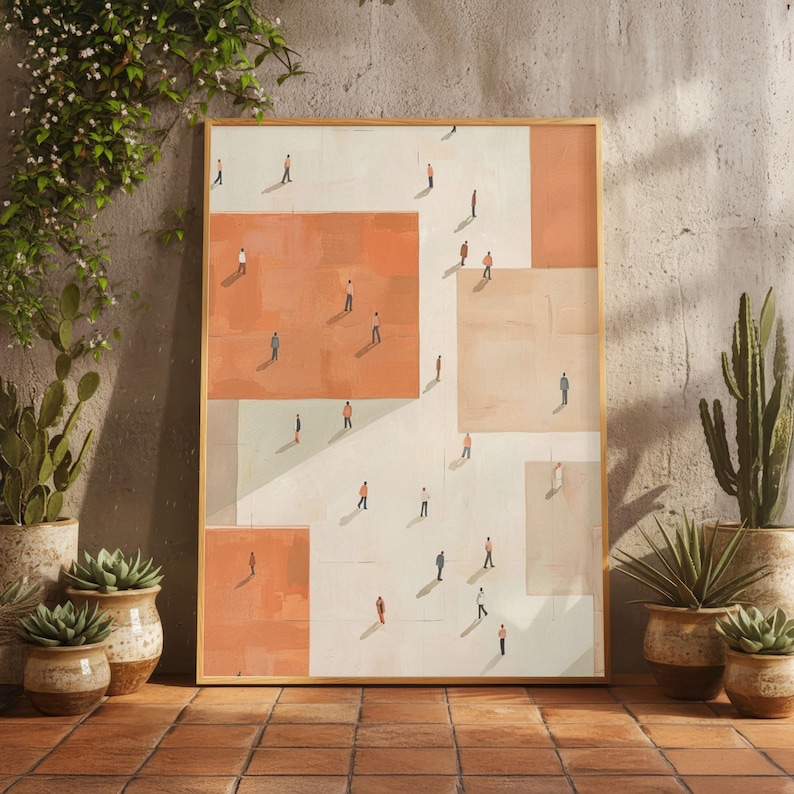 May include: A framed art print featuring an abstract design with geometric shapes in shades of peach, beige, and white. Small figures are scattered across the surface, creating a sense of depth and scale. The artwork is displayed against a neutral wall.