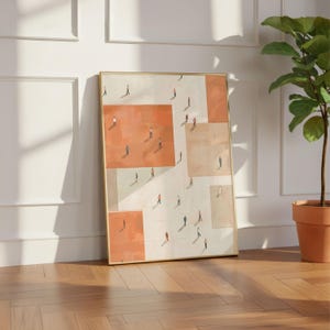 May include: Framed art print featuring an abstract design with geometric shapes in shades of peach, beige, and white. Small figures of people are scattered across the surface. The artwork is displayed in a gold frame, leaning against a white wall.