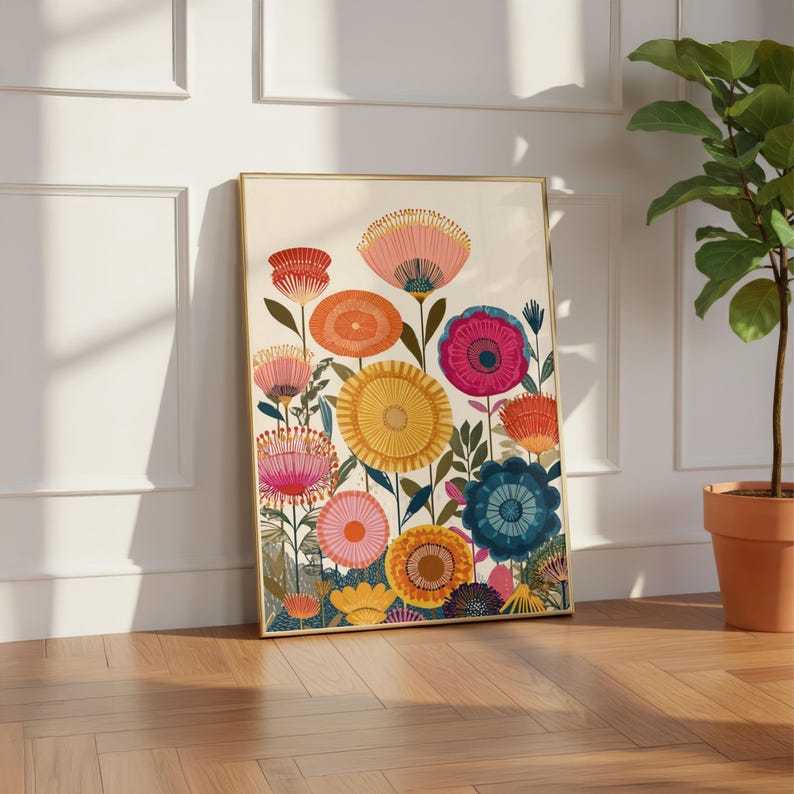 May include: A framed art print featuring a colorful floral design. The artwork showcases a variety of stylized flowers in shades of pink, orange, yellow, and blue against a cream background. The frame is gold-toned, adding a touch of elegance.