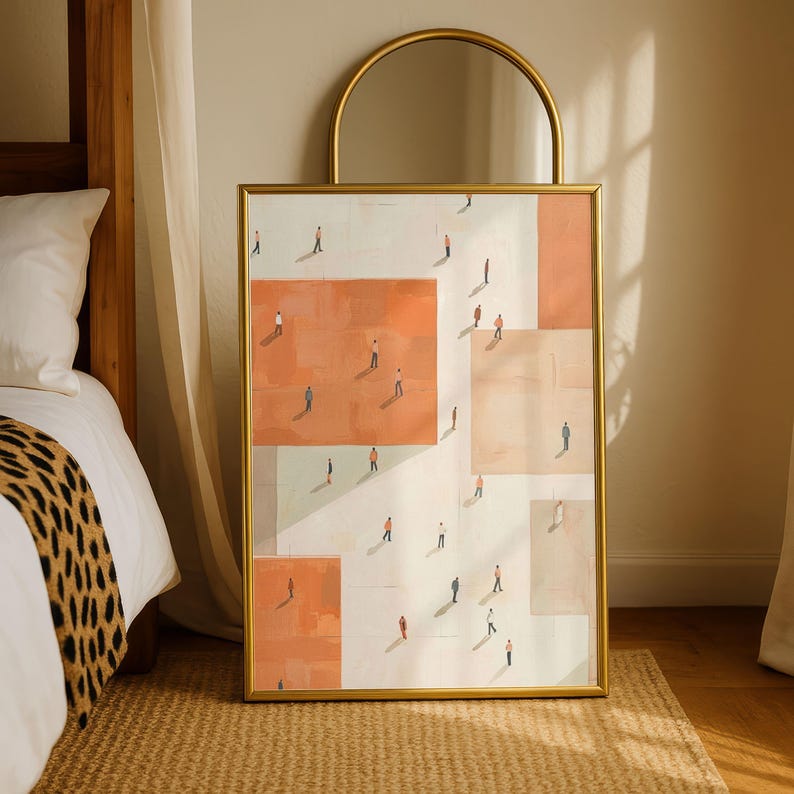 May include: Framed art print featuring an abstract design with geometric shapes in shades of peach, white, and beige. Tiny figures are scattered across the surface, creating a sense of depth. The print is encased in a gold frame, adding a touch of elegance.