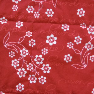 May include: Red fabric with a white floral pattern and the words "Hope" and "Dream" repeated throughout.
