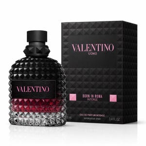 May include: A white ceramic mug with a black handle and the text "But First, Coffee" in a handwritten style. The mug is on a white surface. The mug is approximately 4 inches tall.