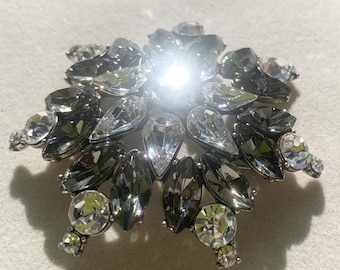 Vintage Neiman Marcus large sunburst snowflake brooch pin white smokey gray rhinestones.
