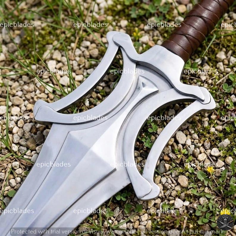 May include: A silver-colored metal sword featuring a complex, open-work crossguard with curved elements and a brown leather-wrapped handle. The blade has a central ridge and a polished finish, with the text epicblades repeated across the image.