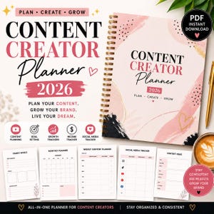 May include: A 2026 spiral-bound content creator planner with a pink and black abstract cover design. The planner features sections for yearly goals, monthly planning, weekly content, social media tracking, and content ideas with text throughout.