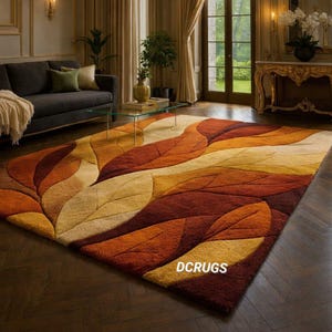showcases a luxurious abstract area rug designed with an organic autumn leaf motif in rich, earthy tones of rust orange, burnt sienna, mustard yellow, golden beige, and deep brown. The sculpted, hand-tufted texture creates a dimensional effect, giving each overlapping leaf shape a raised, plush surface that enhances both visual depth and tactile comfort. The design features flowing, curved leaf forms that stretch diagonally across the rug, forming a dynamic composition