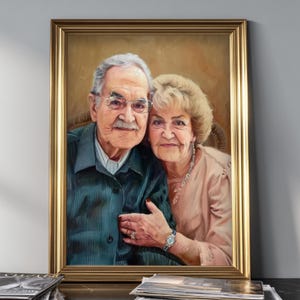 May include: A framed portrait painting of an elderly couple. The person on the left has gray hair, a mustache, and wears glasses and a dark teal collared shirt. The person on the right has blonde hair and wears a light pink top and a silver necklace.