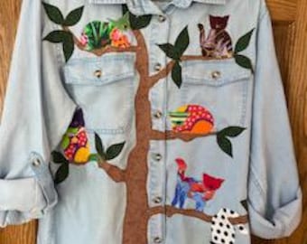 Chambray/denim shirt appliqued "cats galore"  sitting in a tree, each with a bead nose, embroidered whiskers, and one with a paw-tag collar.