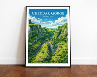 May include: A framed print featuring Cheddar Gorge in Somerset, England. The image showcases a winding road through a lush green valley, flanked by towering cliffs. The sky is blue with fluffy white clouds, and the text "Cheddar Gorge Somerset" is at the top.