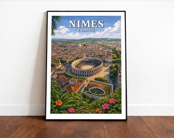 May include: Framed art print of Nimes, France, featuring a detailed aerial view of the city, including the Roman amphitheater. The print has a black frame and is displayed on a wooden floor. The sky is blue with white clouds.