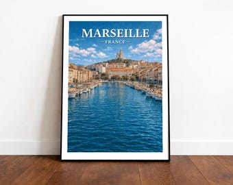 May include: Framed print of Marseille, France, featuring a vibrant blue harbor with boats, buildings, and a church on a hill under a cloudy sky. The word "Marseille" is displayed at the top.