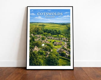 May include: A framed print featuring an aerial view of the Cotswolds, England. The image showcases a village nestled among green trees and fields under a blue sky with clouds. The text "Cotswolds England" is displayed at the top.