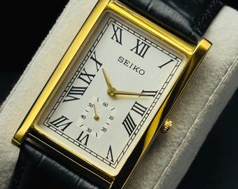 Rare Vintage Seiko Slim Gold Rectangular Seiko wrist watch Black leather strap, Roman numerals