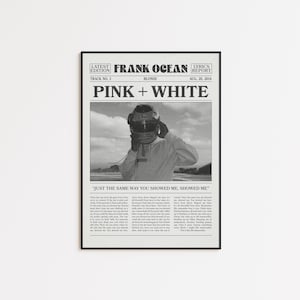 May include: Black and white framed print featuring a newspaper-style design. The headline reads "PINK + WHITE" with "FRANK OCEAN" and "BLONDE" text. A photo of a person wearing a helmet is in the center. Lyrics are printed below.