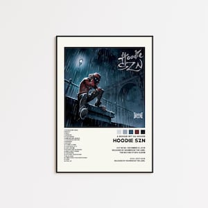 Może przedstawiać: Oprawiony plakat z okładką albumu "Hoodie SZN" A Boogie Wit Da Hoodie. Grafika przedstawia osobę w czerwonej bluzie z kapturem na deszczu. Plakat zawiera tytuł albumu, listę utworów i informacje o wydaniu.