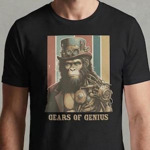 May include: Black t-shirt with a steampunk ape design. The ape wears a top hat and has a mechanical arm. The background has vertical stripes in brown, red, blue, and yellow. The text "GEARS OF GENIUS" is printed below the ape.