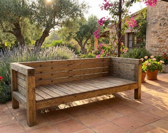May include: A rustic wooden outdoor bench with a slatted seat and backrest. The bench is made of weathered wood and has a natural finish. It is set on a tiled patio, surrounded by lush greenery and flowering plants.