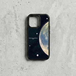 May include: Black phone case with a celestial design. It features a large moon and stars against a dark blue background. The case includes the text: "If you never try, you'll never know."