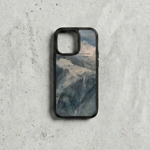May include: Black phone case with a landscape painting of a mountain range and waterfall in shades of blue, green, and white. Text is visible on the upper right. The case has a black border.