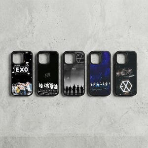 May include: Five black phone cases with various designs. One features the text "EXO" and a group of people. Another has the text "EXO". The third has a grayscale image of people. The fourth has a starry night design. The last has a geometric design.