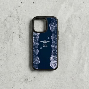 May include: Black phone case with a dark blue ocean wave design. The case features the text "even the darkest night will end and the sun will rise" with two small starfish illustrations.
