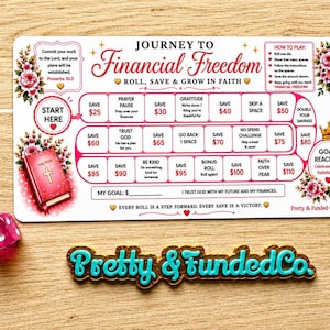 May include: A rectangular game board titled Journey to Financial Freedom with a pink and white color scheme, featuring a path of numbered savings spaces, floral illustrations, a Holy Bible graphic, a pink six-sided die, and a Pretty & Funded Co. sign.