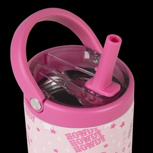 May include: Pink insulated tumbler with a matching handle and lid. The lid features a clear plastic section and a pink straw. The tumbler's exterior is decorated with white stars and the word "HOWDY" in pink. A silver button is on the side.