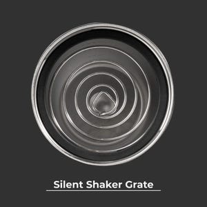 May include: A top-down view of a stainless steel silent shaker grate. The grate features a coiled wire design within a black rubber ring and a silver rim. The text "Silent Shaker Grate" is displayed at the bottom of the image.