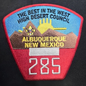 May include: Embroidered patch with a red, white, blue, yellow, and brown design. The patch reads "THE BEST IN THE WEST HIGH DESERT COUNCIL" and "ALBUQUERQUE NEW MEXICO". The number "285" is prominently displayed.