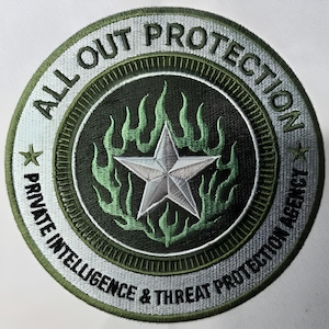 May include: Circular patch with the text "ALL OUT PROTECTION PRIVATE INTELLIGENCE & THREAT PROTECTION AGENCY." The patch features a silver star in the center, surrounded by green flames, and a silver and green border.