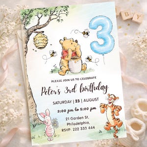 May include: A birthday invitation featuring Winnie the Pooh characters. The invitation includes a blue number 3 balloon, a honey pot, and the text "Peter's 3rd birthday". The invitation also includes the date, time, and location.