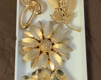 7 vintage designer gold tone brooches