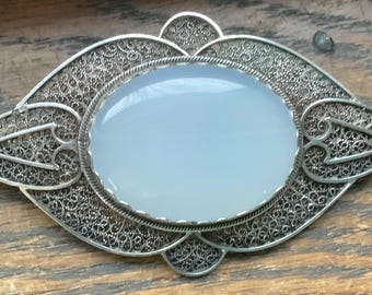 ornate sterling silver filigree brooch with large cabochon moonstone