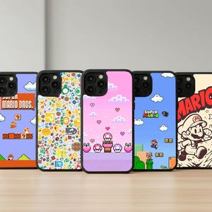 May include: Five phone cases with black borders, each featuring a different design inspired by the Super Mario Bros. video game. Designs include pixelated characters, level layouts, and the Mario logo. The cases have a glossy finish.