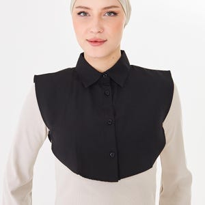 May include: A white ceramic mug with a black handle and the text "But First, Coffee" in a bold, black font. The mug is set against a blurred background, suggesting a cozy setting. The mug appears to be approximately 4 inches tall.