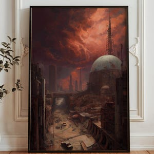 Puede incluir: Impresión artística enmarcada que representa un paisaje urbano distópico bajo un cielo rojo dramático y ardiente. La obra presenta una estructura en forma de cúpula, edificios altos y una red de carreteras y estructuras, todo ello en tonos apagados y terrosos.