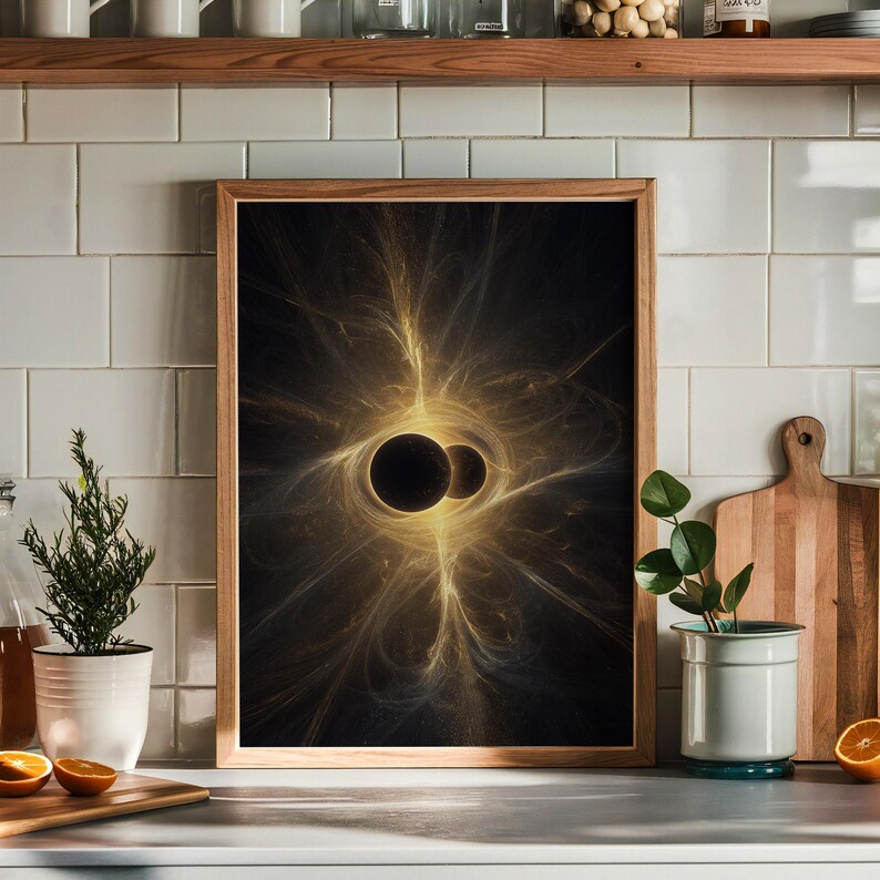 May include: A framed art print featuring a digital abstract design. The artwork showcases two dark, spherical shapes surrounded by radiating golden light against a black background. The frame is made of light-colored wood.