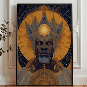 May include: Framed art print featuring a stylized portrait of a person with a crown and beard. The artwork uses a color palette of gold, blue, and black. The person's face is centered, with a radiant sun-like element behind the head.