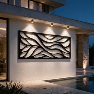 May include: A large rectangular black metal wall art panel featuring an intricate cutout design of flowing, organic wave-like patterns. The piece is mounted horizontally on a light-coloured exterior wall, illuminated by overhead recessed lighting.