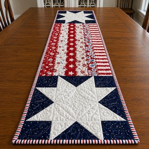 May include: A patriotic table runner with a star and stripe design. The runner features white stars on a blue background at each end, with red and white stripes and floral patterns in the center. The edges are trimmed with a red, white, and blue striped border.