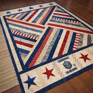 May include: A patriotic quilt featuring red, white, and blue stripes and stars. The quilt has a cream-colored background with a blue border and includes the text "Courage" and "U.S. Air Force".