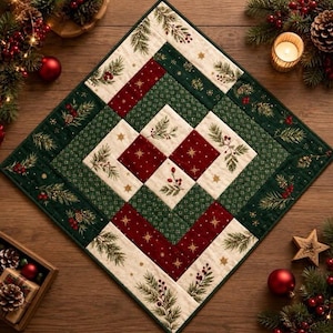 May include: A square quilted table topper featuring a geometric patchwork design in cream, dark green, and deep red. The fabric displays patterns of pine branches, red berries, and gold stars. The quilted textile has a finished stitched border.